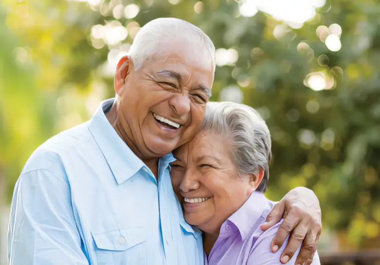 A senior couple embracing and laughing
