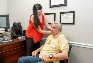 Lauren Harris, Au.D. performing a hearing evaluation on a patient